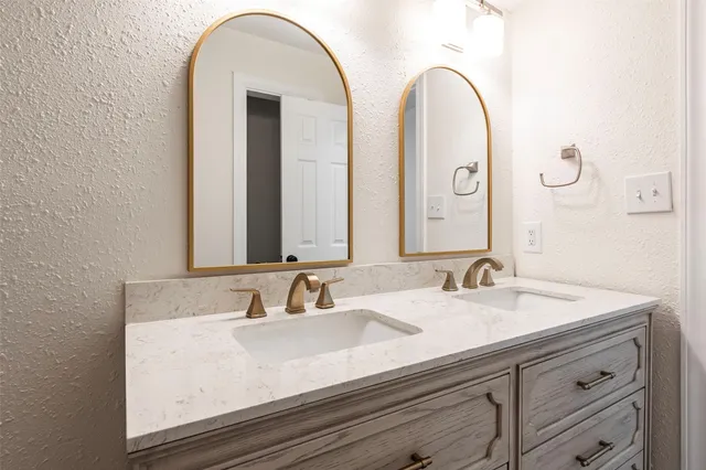 a bathroom with a double vanity sink and a mirror