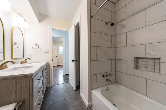 a bathroom with a tub sink and mirror