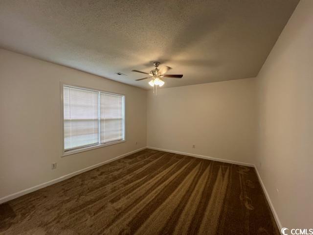 1809 Barberry Drive Conway, SC 29526 - Photo 13 of 16 Spare room with dark colored carpet, a textured ce