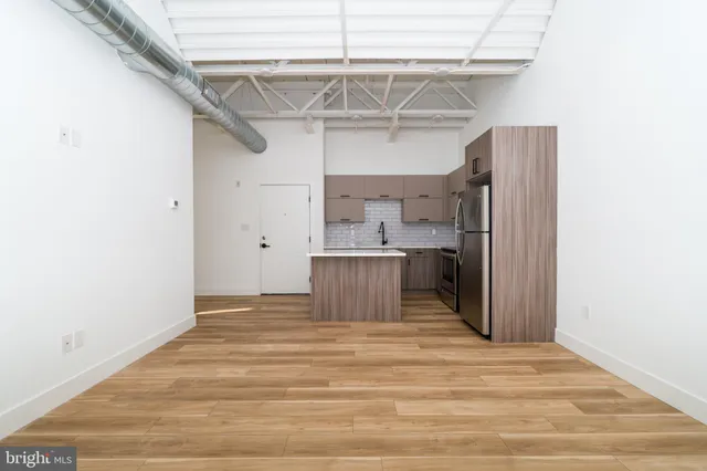 a view of a kitchen with wooden floor