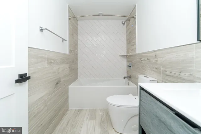 a bathroom with a sink a toilet and a bathtub