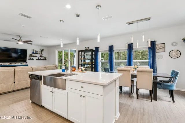 a kitchen with a sink and chairs
