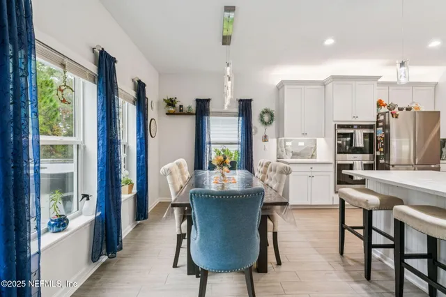 a view of a dining room with furniture window and outside view