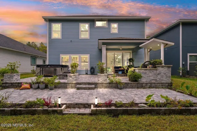 a front view of a house with a large garden