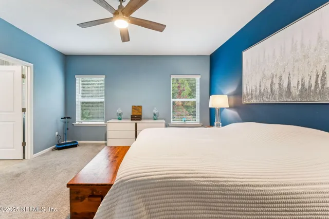 a bedroom with a large bed and a large window