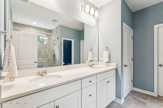 a bathroom with a sink double vanity and a mirror