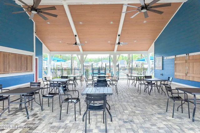 a view of a swimming pool with a table and chairs