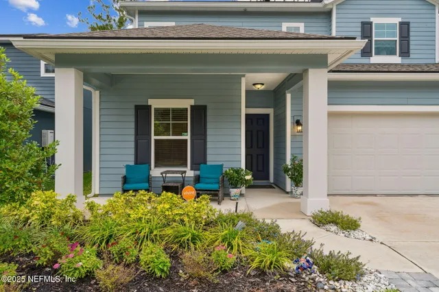 front view of the house with potted plants