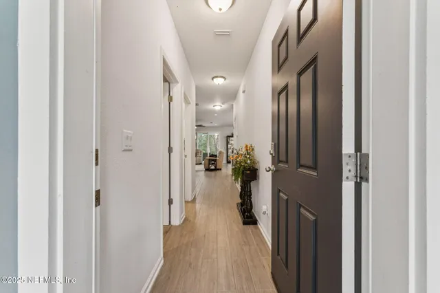 a view of a hallway with a livingroom with furniture