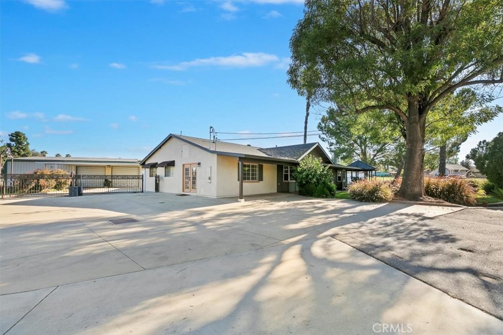 18590 Roberts Road Riverside, CA 92508 - Photo 13 of 66 a front view of a house with a yard and garage