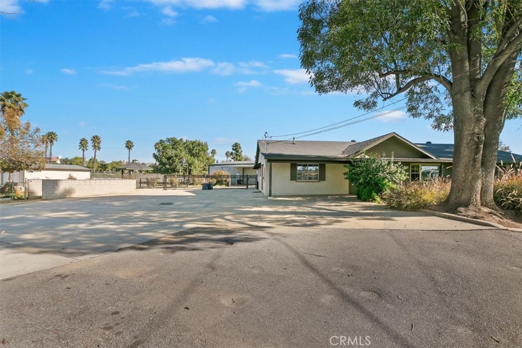 18590 Roberts Road Riverside, CA 92508 - Photo 15 of 66 a front view of a house with a yard and large trees