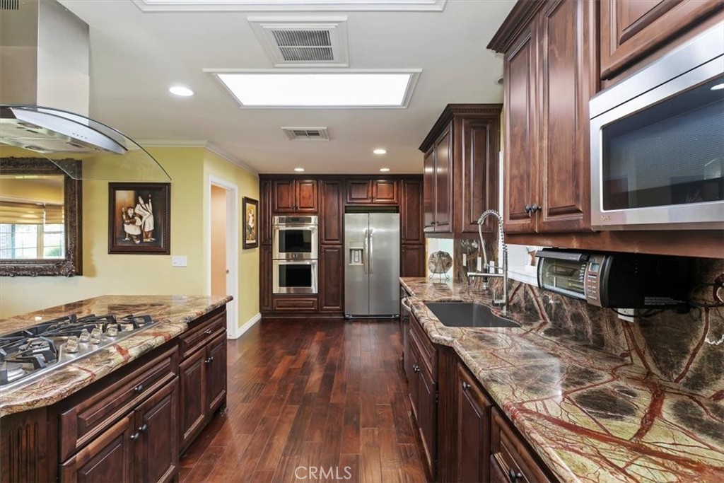 18590 Roberts Road Riverside, CA 92508 - Photo 26 of 66 a kitchen with granite countertop a stove and a sink