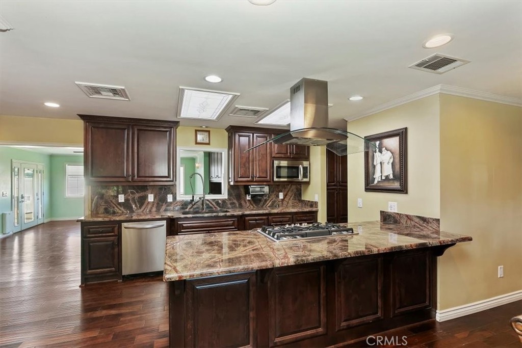 18590 Roberts Road Riverside, CA 92508 - Photo 27 of 66 a kitchen with stainless steel appliances granite countertop a sink and a refrigerator
