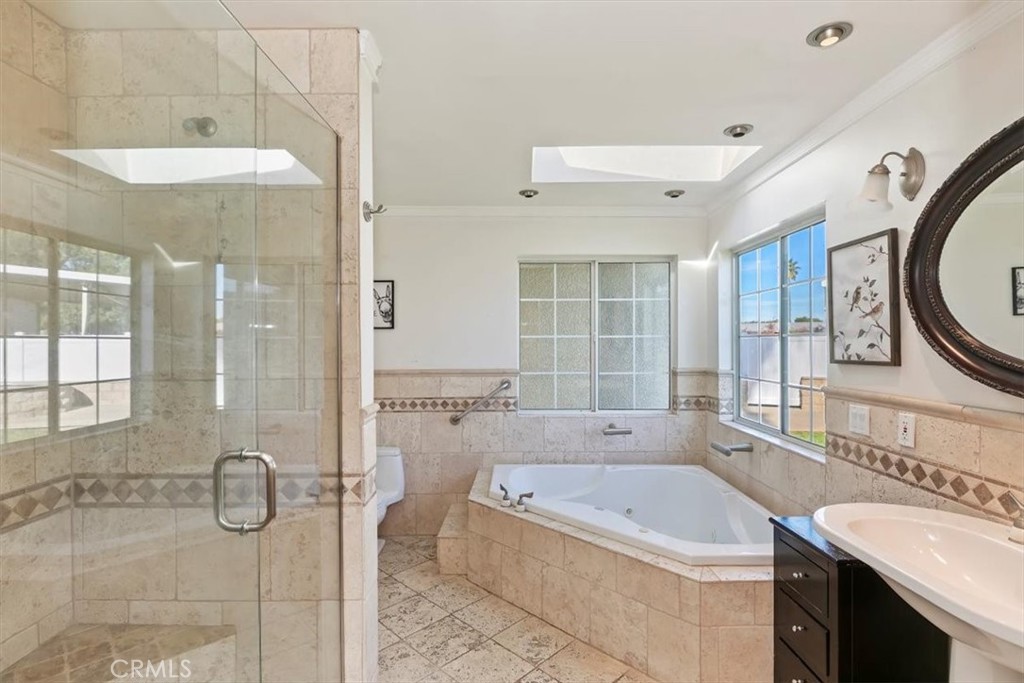 18590 Roberts Road Riverside, CA 92508 - Photo 40 of 66 a bathroom with a granite countertop tub a sink and a large mirror