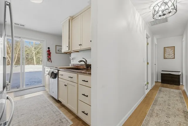 a kitchen with granite countertop a sink and a stove top oven