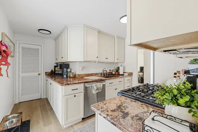 a kitchen with sink stove and cabinets