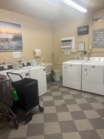 a living room with furniture a flat screen tv and a window