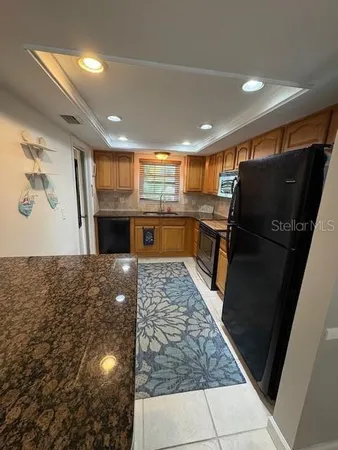 a kitchen with a refrigerator and a sink