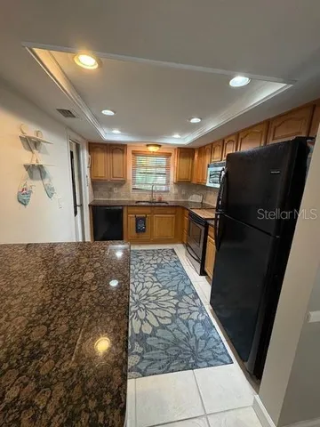a kitchen with a refrigerator and a sink