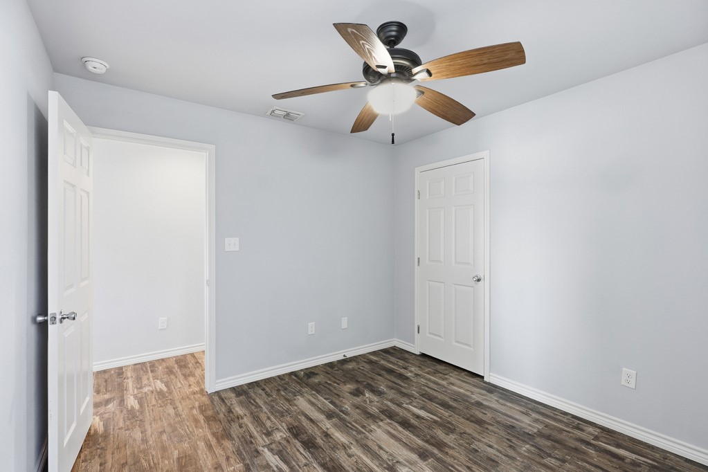 2121 Lone Star Road Rockport, TX 78382 - Photo 13 of 29 a view of an empty room with wooden floor