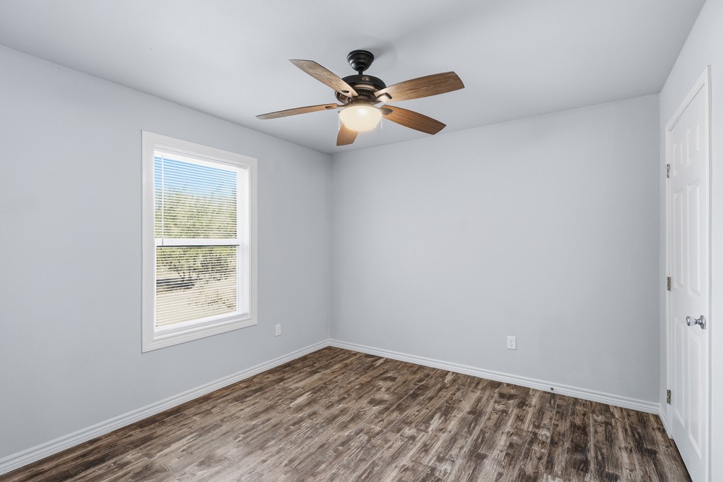 2121 Lone Star Road Rockport, TX 78382 - Photo 15 of 29 wooden floor in an empty room with a window