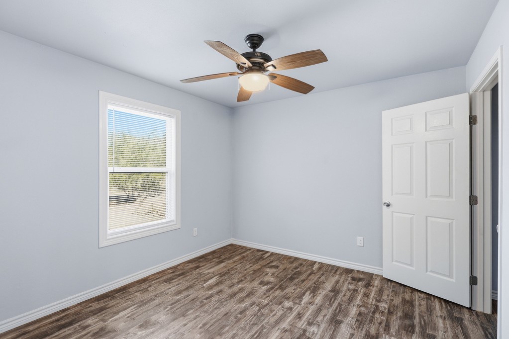 2121 Lone Star Road Rockport, TX 78382 - Photo 16 of 29 wooden floor in an empty room with a window