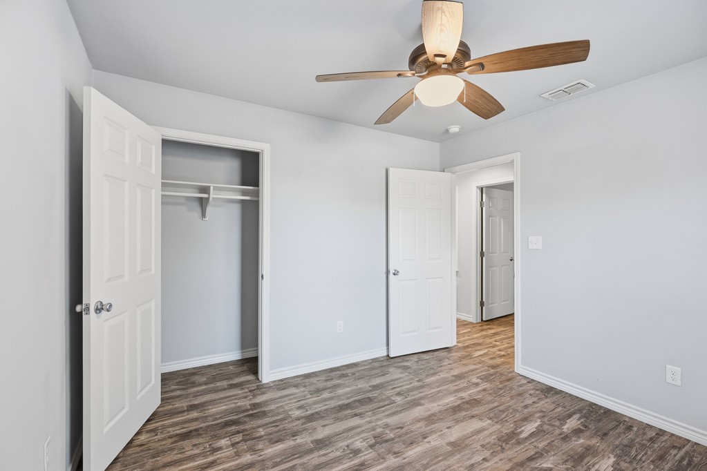 2121 Lone Star Road Rockport, TX 78382 - Photo 17 of 29 a view of empty room with wooden floor and fan