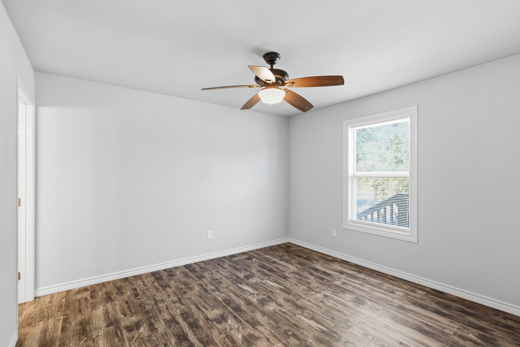 2121 Lone Star Road Rockport, TX 78382 - Photo 18 of 29 a view of empty room with wooden floor and fan
