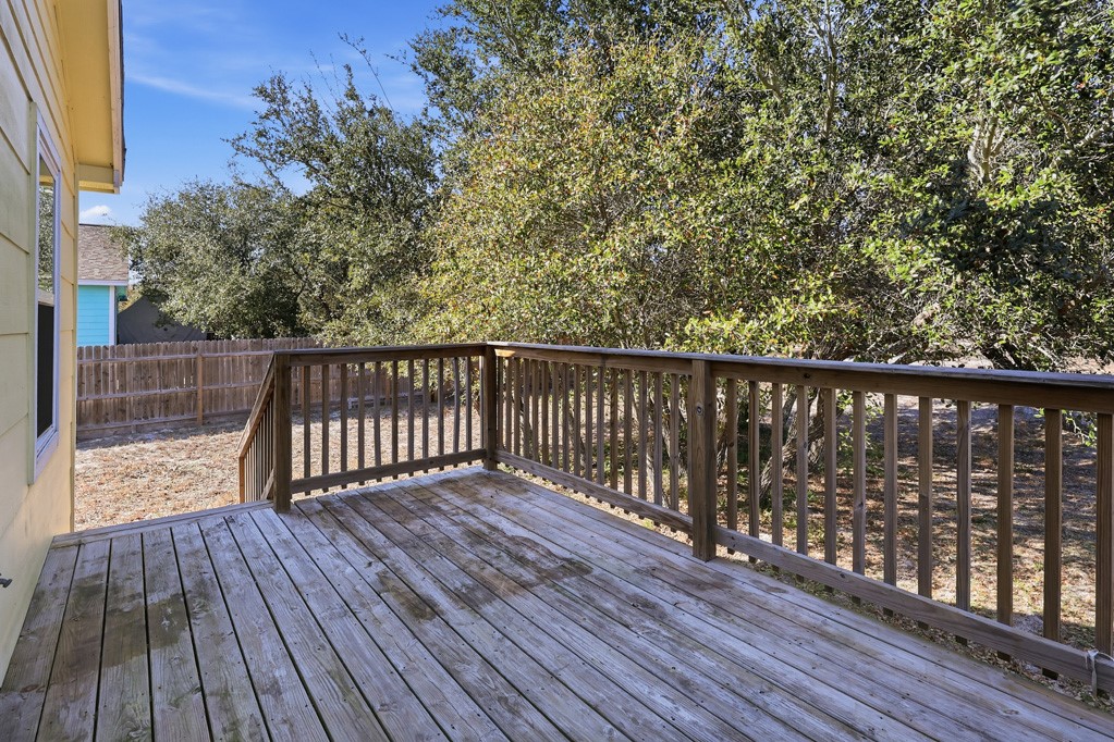 2121 Lone Star Road Rockport, TX 78382 - Photo 27 of 29 a balcony with wooden floor and fence