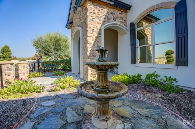 a kitchen with stainless steel appliances a dining table chairs and white cabinets