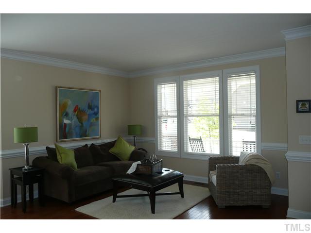 2755 Hidden Waters Circle Raleigh, NC 27614 - Photo 3 of 19 Living room is accented with crown molding, chair rail, hardwood floors and a bay of windows allowing you to enjoy the outdoors while sitting indoors.