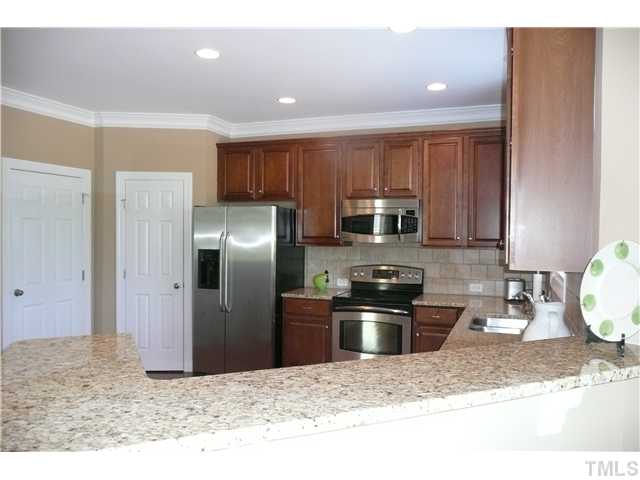 2755 Hidden Waters Circle Raleigh, NC 27614 - Photo 7 of 19 View of the kitchen from the Breakfast nook. This kitchen has raised counters that could easiliy accomodate bar stools providing extra seating for guest and family.