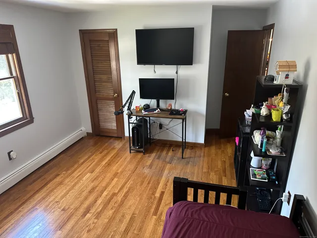 a living room with furniture wooden floor and a flat screen tv