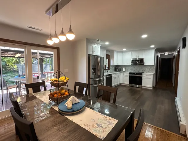 a living room with stainless steel appliances kitchen island granite countertop furniture and a view of kitchen