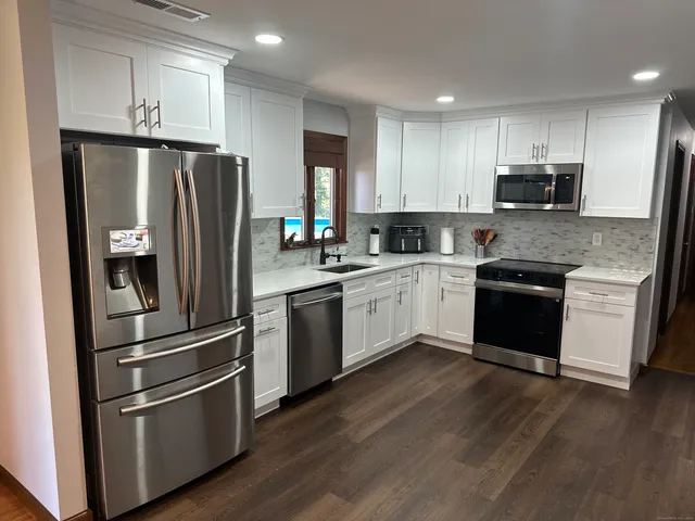 a kitchen with stainless steel appliances and wooden cabinets