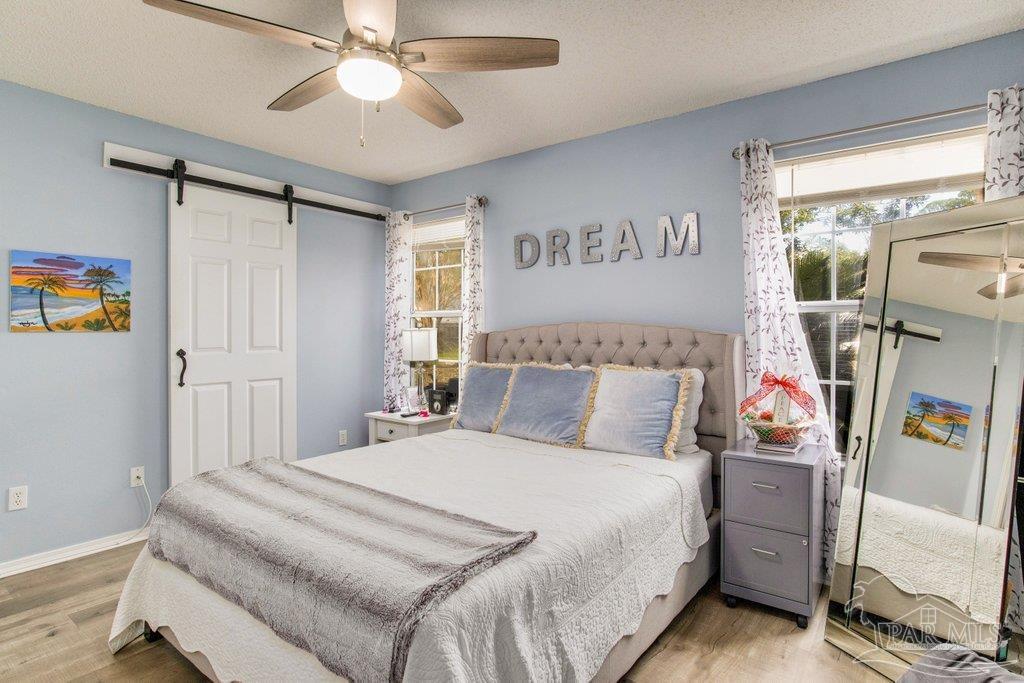 2466 Redoubt Avenue Pensacola, FL 32507 - Photo 14 of 27 a bedroom with a bed and a chandelier