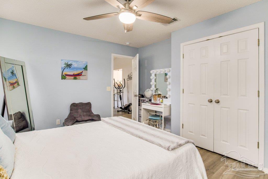 2466 Redoubt Avenue Pensacola, FL 32507 - Photo 16 of 27 a bedroom with a bed and a chandelier