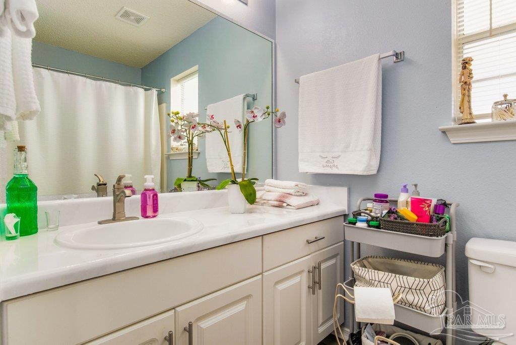 2466 Redoubt Avenue Pensacola, FL 32507 - Photo 17 of 27 a bathroom with a sink and a mirror