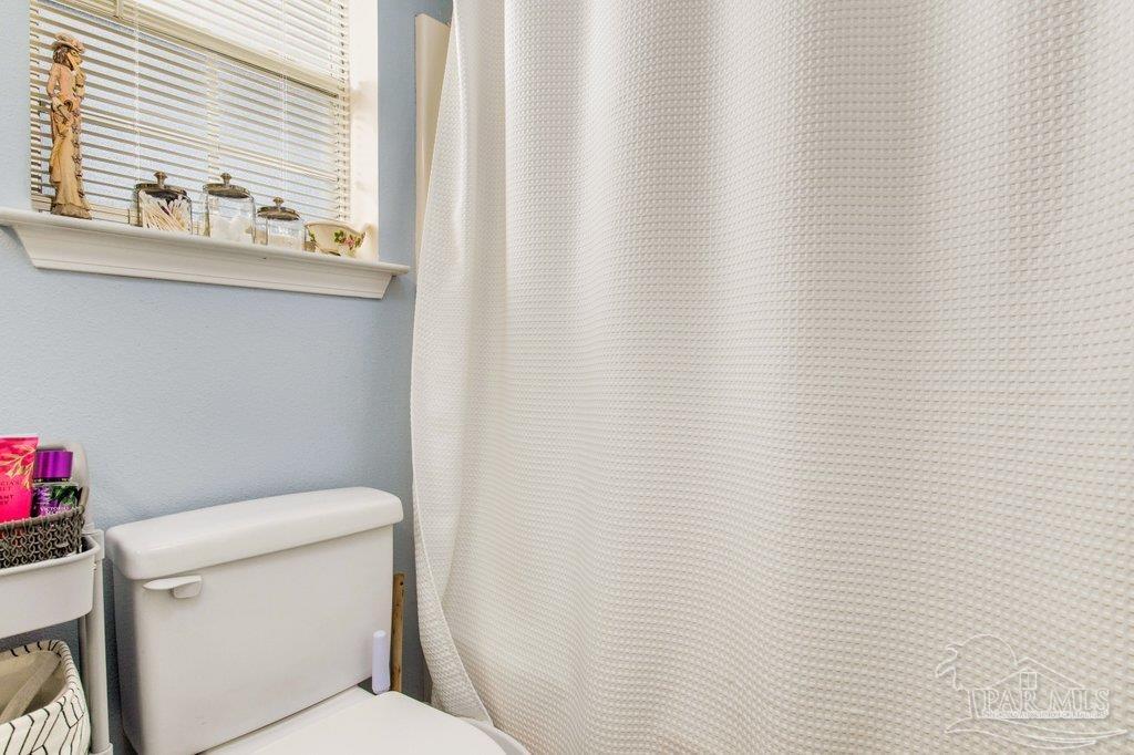 2466 Redoubt Avenue Pensacola, FL 32507 - Photo 18 of 27 a white toilet sitting next to a white sink