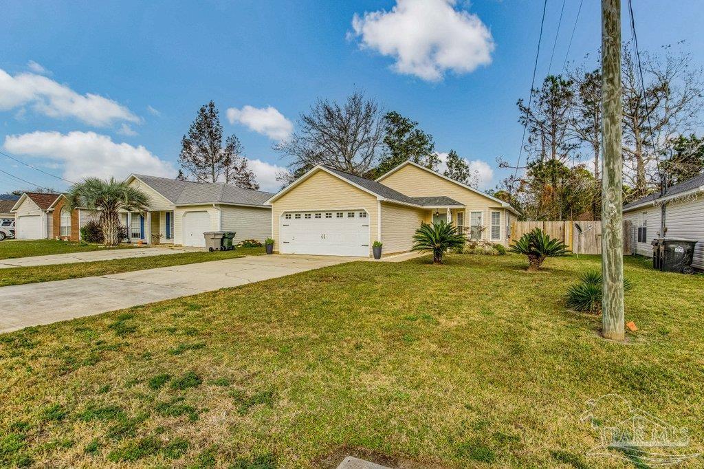 2466 Redoubt Avenue Pensacola, FL 32507 - Photo 2 of 27 a front view of a house with garden