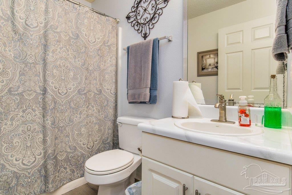 2466 Redoubt Avenue Pensacola, FL 32507 - Photo 22 of 27 a bathroom with a sink and a toilet