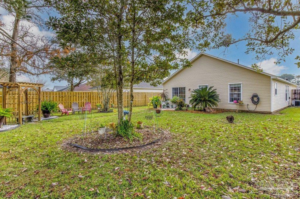 2466 Redoubt Avenue Pensacola, FL 32507 - Photo 23 of 27 a view of a house with backyard and garden