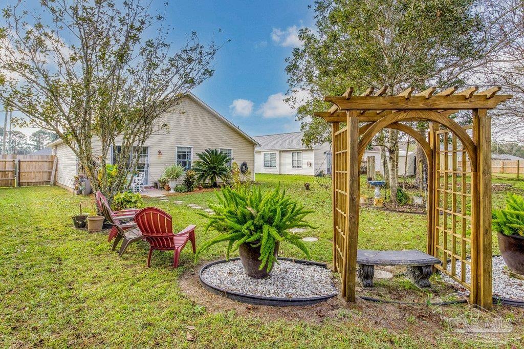 2466 Redoubt Avenue Pensacola, FL 32507 - Photo 25 of 27 a backyard of a house with table and chairs