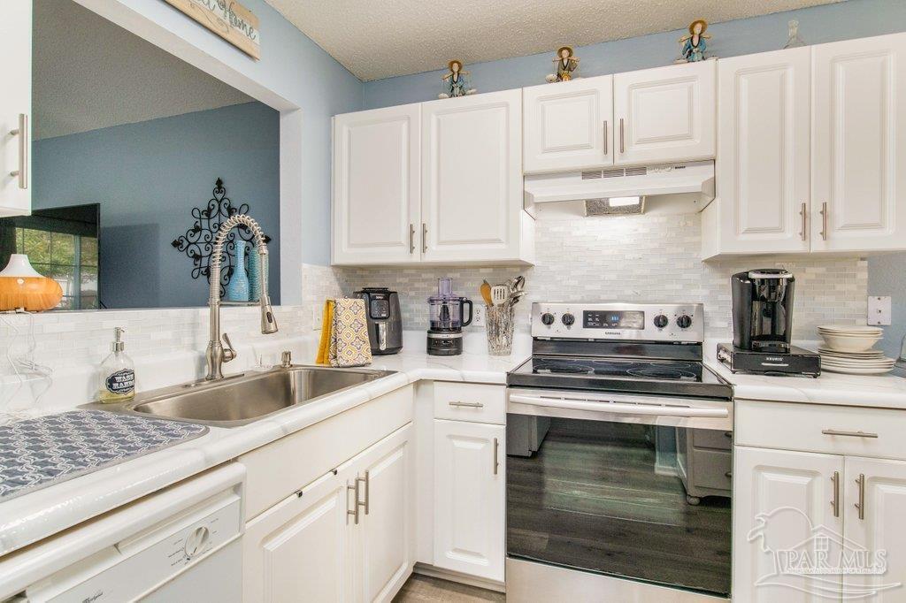 2466 Redoubt Avenue Pensacola, FL 32507 - Photo 6 of 27 a kitchen with cabinets appliances a sink and a counter top space