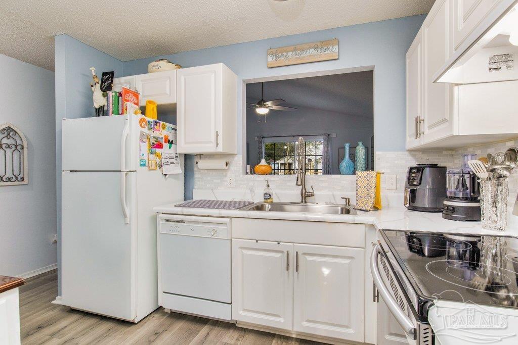 2466 Redoubt Avenue Pensacola, FL 32507 - Photo 7 of 27 a kitchen with appliances a refrigerator and cabinets