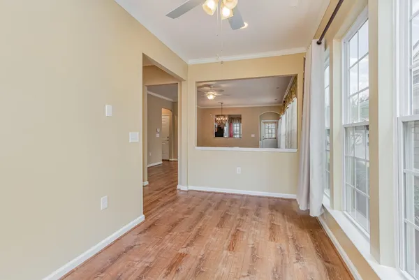 a view of a room with wooden floor and door