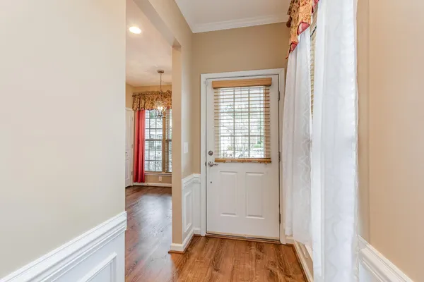 a view of hallway with wooden floor