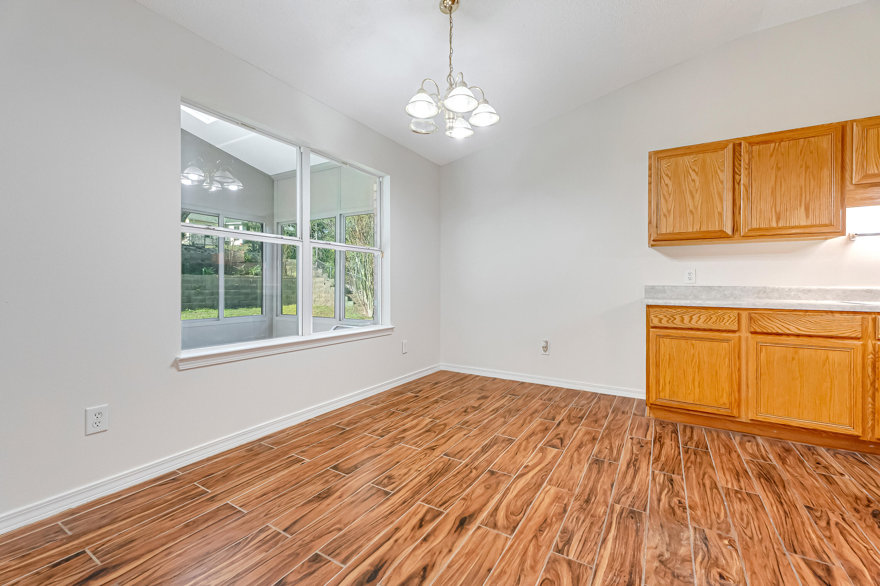 427 Hatchee Drive Crestview, FL 32536 - Photo 14 of 77 a view of empty room with wooden floor and fan