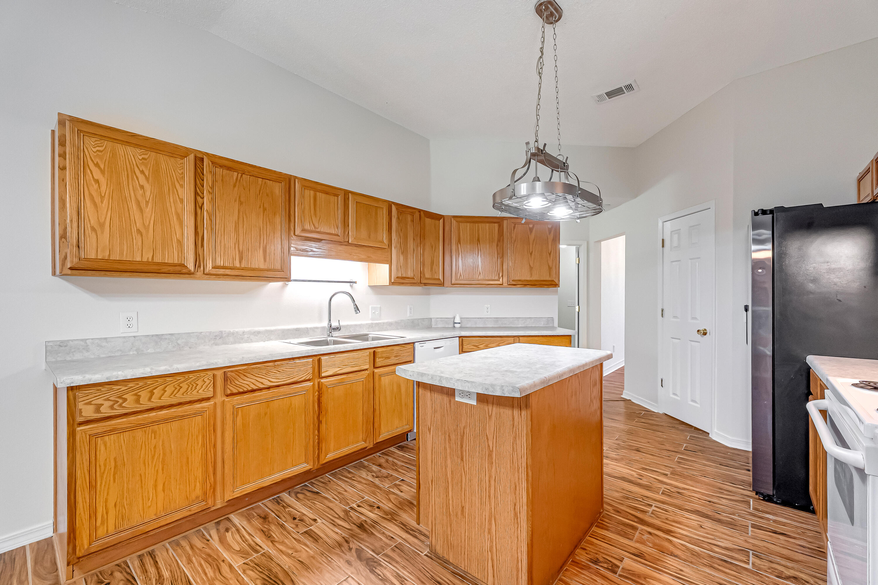 427 Hatchee Drive Crestview, FL 32536 - Photo 16 of 77 a kitchen with stainless steel appliances granite countertop a sink a stove and a wooden floors