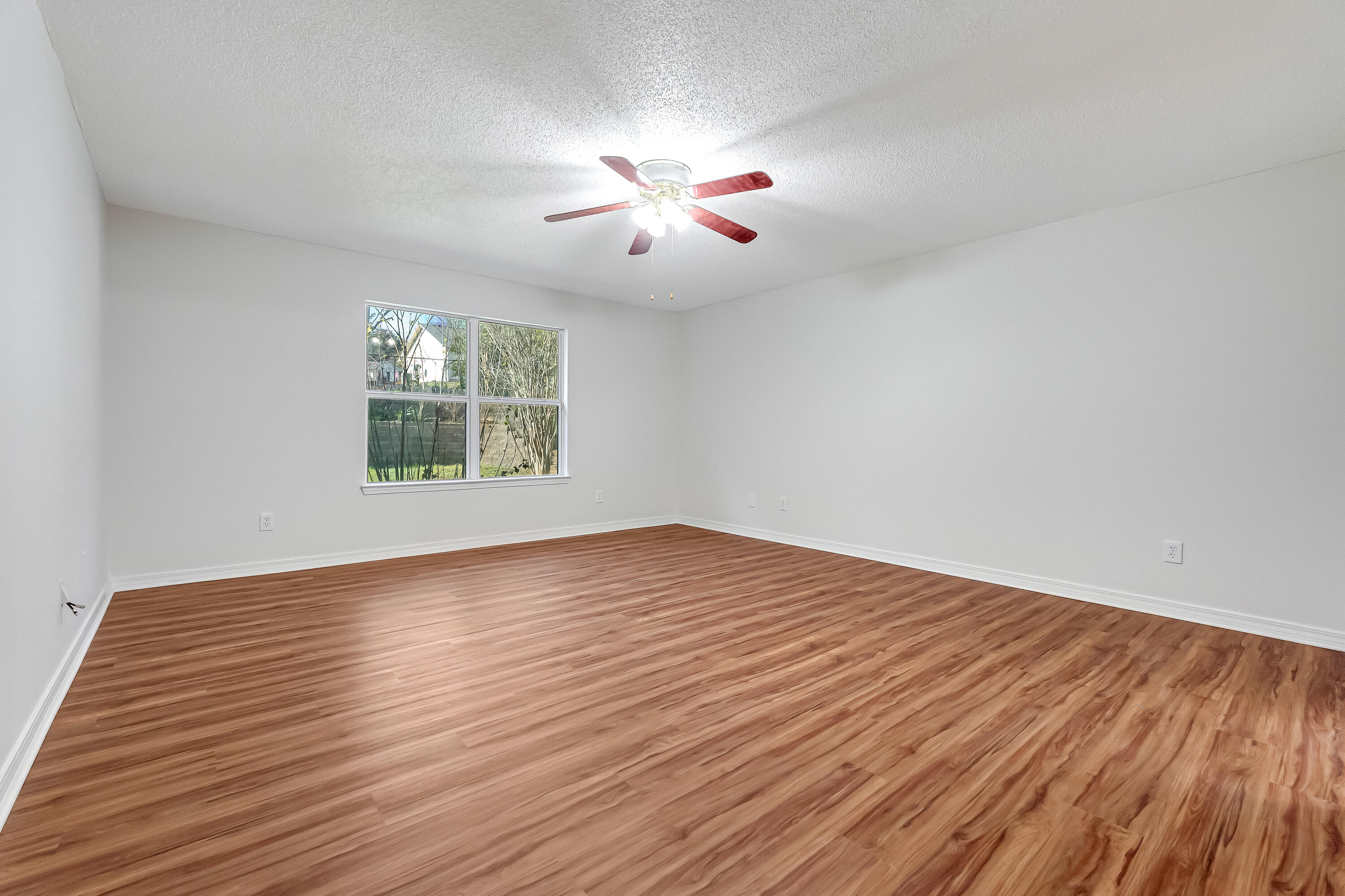 427 Hatchee Drive Crestview, FL 32536 - Photo 30 of 77 wooden floor in an empty room with a window